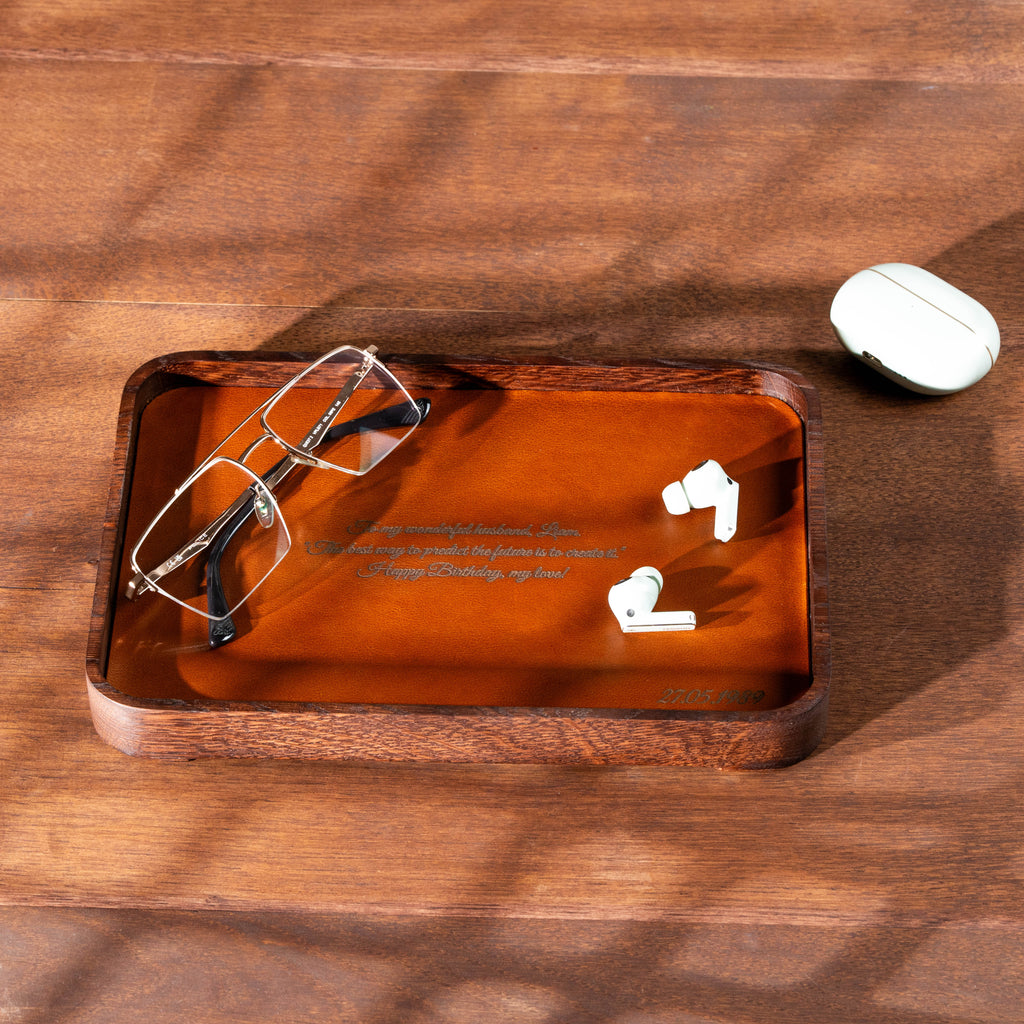 Personalized dark oak valet tray with camel leather and custom laser engraving for everyday essentials.
