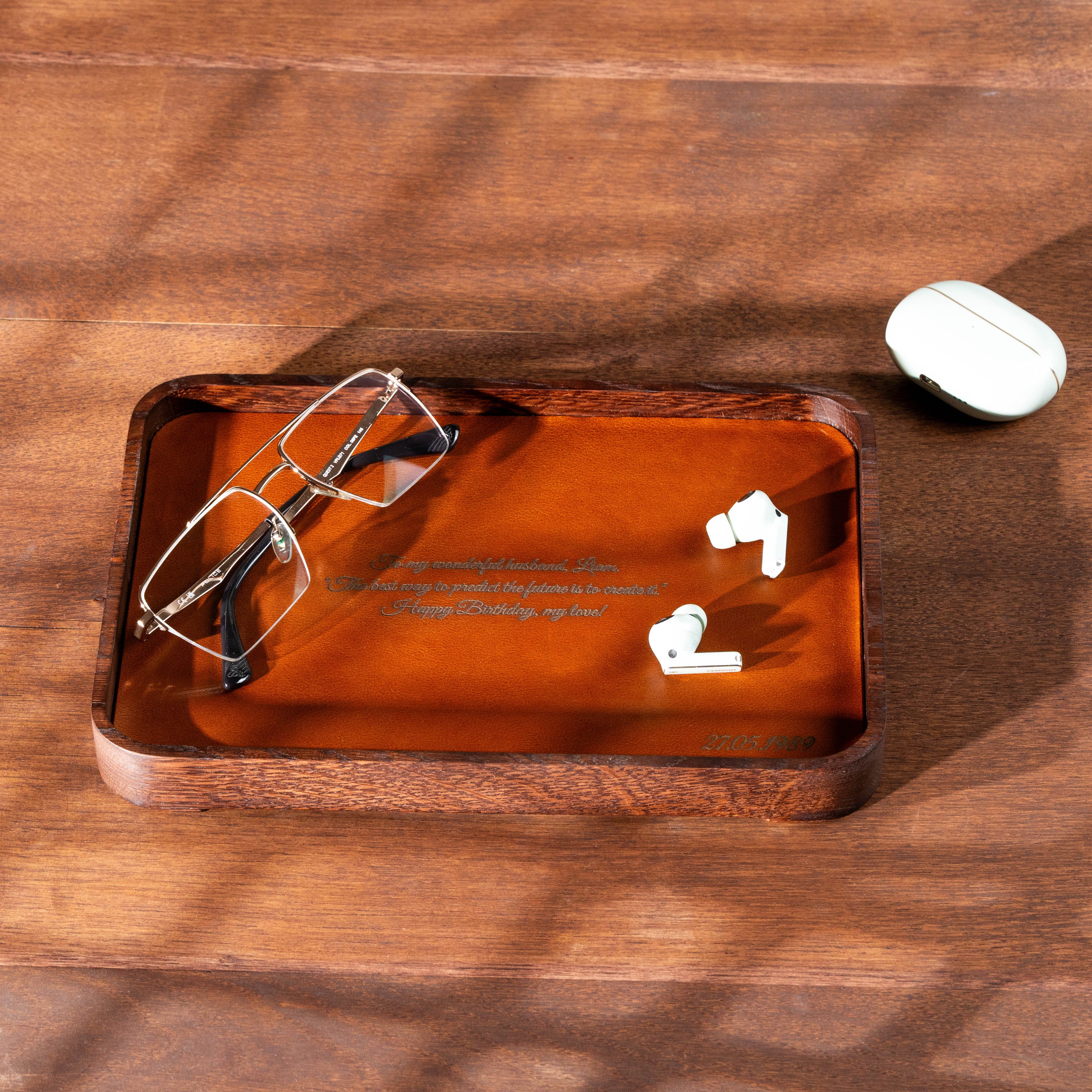 Personalized dark oak valet tray with camel leather and custom laser engraving for everyday essentials.