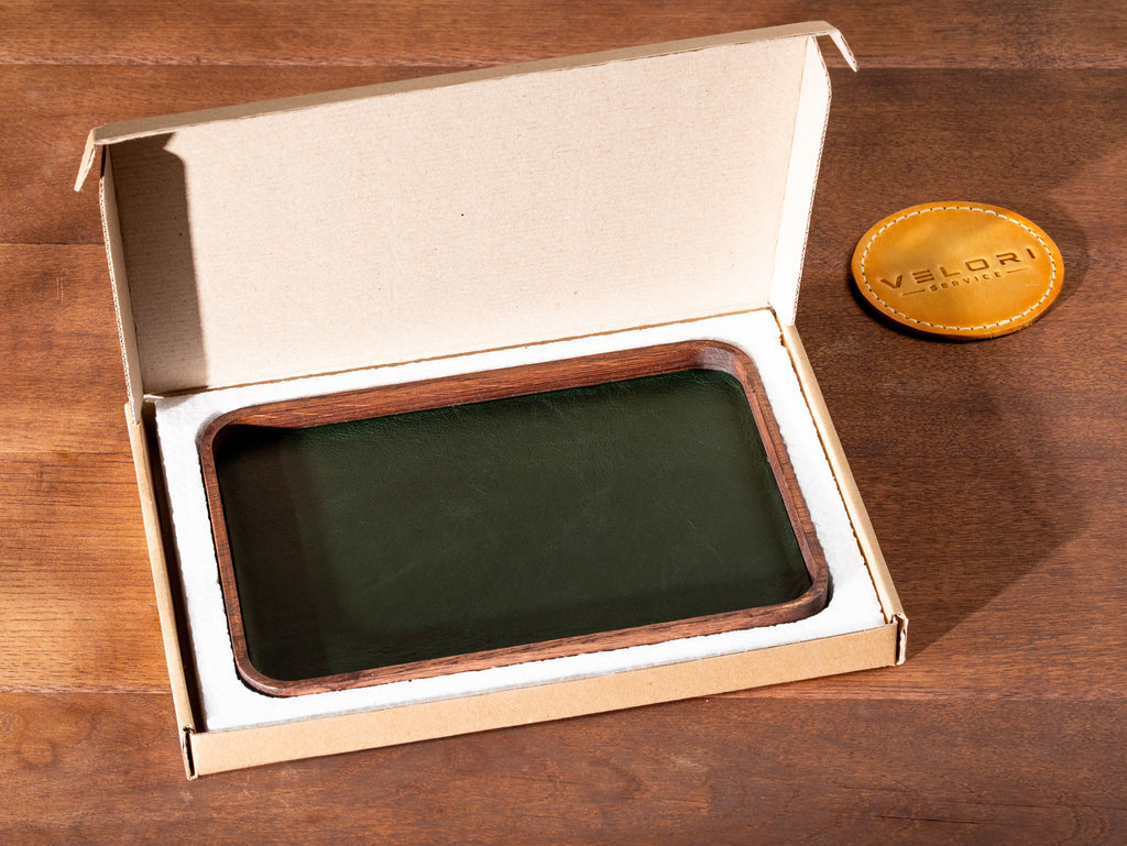 Personalized valet tray with green leather and dark oak wood in secure shipping packaging.